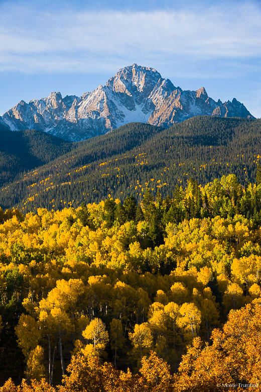 Vibrant fall foliage fills the valley below Mount Sneffels outside of Ridgway, Colorado.