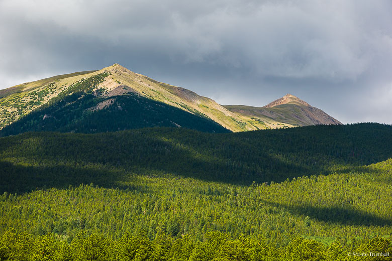 Clouds build over Mount Columbia casting a patchwork of shadows on the mountainside in the San Isabel National Forest outside of Buena Vista, Colorado.